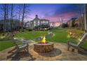 The backyard features a stone fire pit, large grassy area, and a deck that is perfect for entertaining at 775 River Cliff Ct, Suwanee, GA 30024