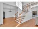 Grand foyer with hardwood floors, staircase, and elegant chandelier; perfect for a welcoming entrance at 775 River Cliff Ct, Suwanee, GA 30024