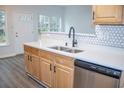 Bright kitchen features stainless steel appliances, white countertops and modern fixtures at 247 Brookview Dr, Riverdale, GA 30274