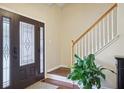 Elegant entryway with stained-glass door, hardwood floors, and white-railed staircase at 359 Interlake Pass, Mcdonough, GA 30252