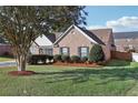 A well-maintained brick home with lush green lawn and tidy landscaping at 359 Interlake Pass, Mcdonough, GA 30252