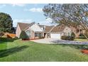 Beautiful one-story brick home boasts a well-manicured lawn and inviting driveway at 359 Interlake Pass, Mcdonough, GA 30252
