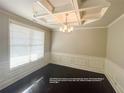 Dining area with picture frame chair rail, coffered ceilings, and plenty of natural light at 404 Providence Walk St, Canton, GA 30114