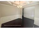 Dining room with decorative chair rail and elegant chandelier lighting at 404 Providence Walk St, Canton, GA 30114