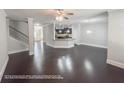 Open-concept living room, dining area, and kitchen with granite countertops and breakfast bar at 404 Providence Walk St, Canton, GA 30114