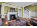 Cozy living room features a fireplace, hardwood floors, and a staircase to the upper level at 189 Westminster Dr, Atlanta, GA 30309