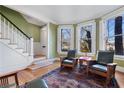 Inviting living room with hardwood floors, staircase access, and bay windows providing ample natural light at 189 Westminster Dr, Atlanta, GA 30309