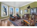 Bright living room featuring hardwood floors, large windows with stylish shutters, and comfortable seating at 189 Westminster Dr, Atlanta, GA 30309