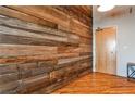 Hallway featuring an accent wall of wooden planks and hardwood floors at 3180 Mathieson Ne Dr # 806, Atlanta, GA 30305