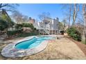 Backyard featuring a kidney-shaped pool with a concrete surround and multi-tiered deck at 325 Wynland Trce, Sandy Springs, GA 30350