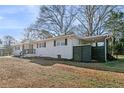 Exterior side view showcasing a well-maintained lawn and modern design elements at 4013 Oglesby Rd, Powder Springs, GA 30127