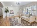 Bright living room featuring hardwood floors, large windows, and stylish decor at 4013 Oglesby Rd, Powder Springs, GA 30127