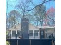 Modern home featuring a dark metal railing deck and a striking dark-gray chimney against a light exterior at 137 Creekview Dr, Woodstock, GA 30188