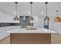Modern kitchen featuring a large island with stylish pendant lighting at 137 Creekview Dr, Woodstock, GA 30188