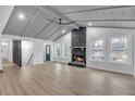 Bright living room with a stone fireplace, vaulted ceilings, large windows, and wood flooring at 137 Creekview Dr, Woodstock, GA 30188