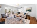 Bright living room with hardwood floors, neutral tones, and comfortable seating arrangement at 4240 Parnell Rd, Marietta, GA 30062