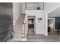 Inviting foyer with a staircase, hardwood floors, and views into the kitchen and living areas at 4350 White Surrey Nw Dr, Kennesaw, GA 30144