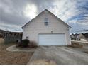 Attached two car garage with adjacent driveway on home needing repairs at 952 Swan Ridge Cir, Grayson, GA 30017