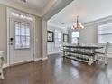 Bright dining room featuring hardwood floors, elegant lighting fixture, and a view to the entryway at 301 Cochin Dr, Woodstock, GA 30188