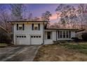 A lovely suburban home is brightly lit by the sunset at 5498 Stoneybrook Se Ct, Mableton, GA 30126