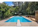 A diving board sits at the end of a large in-ground pool at 5498 Stoneybrook Se Ct, Mableton, GA 30126