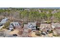 Aerial view of a home in a wooded neighborhood, surrounded by lush trees and well-maintained lawns at 106 Birchwood Pass, Canton, GA 30114