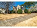 Charming two-story home with well-manicured landscaping, mature trees, and a curved driveway at 3287 Belmont Glen Se Dr, Marietta, GA 30067