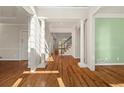 Elegant foyer with hardwood floors, stately columns, and views of the staircase at 3287 Belmont Glen Se Dr, Marietta, GA 30067