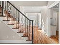 Ornate wrought iron staircase and hardwood floors leading from the main foyer of the home at 3287 Belmont Glen Se Dr, Marietta, GA 30067