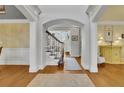 Bright foyer with hardwood floors, arched doorways, and a view of the staircase at 1728 Holcomb Lake Rd, Marietta, GA 30062
