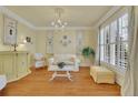 Elegant living room with large windows, a decorative chandelier, and stylish furnishings at 1728 Holcomb Lake Rd, Marietta, GA 30062