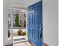 Open blue front door of a townhome with modern hardware and a view of the neighborhood at 1868 Appaloosa Mill Ct, Buford, GA 30519