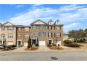 Attractive townhomes with individual driveways and manicured front yards along a well-maintained street at 1868 Appaloosa Mill Ct, Buford, GA 30519