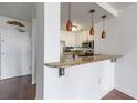 Kitchen view with bar top counter and stainless steel appliances, pendant lighting and hardwood floors at 375 Ralph Mcgill Ne Blvd # 807, Atlanta, GA 30312