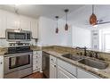 Modern kitchen features stainless steel appliances, granite countertops, and beautiful pendant lighting, with a breakfast bar at 375 Ralph Mcgill Ne Blvd # 807, Atlanta, GA 30312