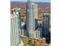 Stunning aerial view of high-rise condos with rooftop pool and lush green landscaping at 855 Peachtree Ne St # 2912, Atlanta, GA 30308