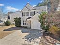 Two-story home with an attached one car garage and a concrete driveway in a suburban neighborhood at 1091 Dunedin Trl, Woodstock, GA 30188