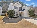 Well-maintained two-story home featuring an attached one car garage and a concrete driveway at 1091 Dunedin Trl, Woodstock, GA 30188