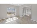 A bright room with hardwood floors, white trim, and natural sunlight at 1516 Montauk Pt, Conyers, GA 30013