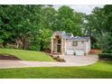 Charming home with brick and stone accents, lush landscaping, and a two-car garage at 3290 Coachmans Ne Way, Roswell, GA 30075