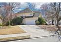 The home's exterior shows a large garage with a basketball hoop, set against a yard with mature trees at 3500 Fieldstone Xing, Alpharetta, GA 30005