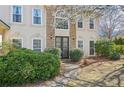 The home features a beautiful stone facade with arched windows and a well-manicured garden at 3500 Fieldstone Xing, Alpharetta, GA 30005