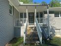Classic porch leads to the front door with a stone staircase and white railings at 3802 Macland Rd, Hiram, GA 30141