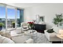 Comfortable living room with neutral tones and access to a balcony with city views at 1080 Peachtree Ne St # 2309, Atlanta, GA 30309