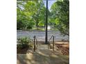 Stone steps lead to street view with lovely pond, trees and fountain at 390 17Th Nw St # 2025, Atlanta, GA 30363