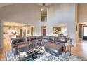 Spacious living room with high ceilings, leather sectional, and views into the kitchen at 4539 Tiffany Ln, Loganville, GA 30052