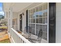 Inviting front porch with seating, offering a cozy outdoor space at 951 Orchard Mill Ln, Lawrenceville, GA 30043