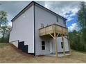 The back exterior of a two-story home includes a small elevated deck and a walk out basement at 108 Deer Xing, Temple, GA 30179