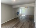 Spacious living area with luxury vinyl plank floors, electric fireplace, and natural light at 108 Deer Xing, Temple, GA 30179