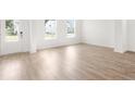 Bright living room features an entrance door, light hardwood floors, and white trim at 202 Groveton Ct, Euharlee, GA 30145
